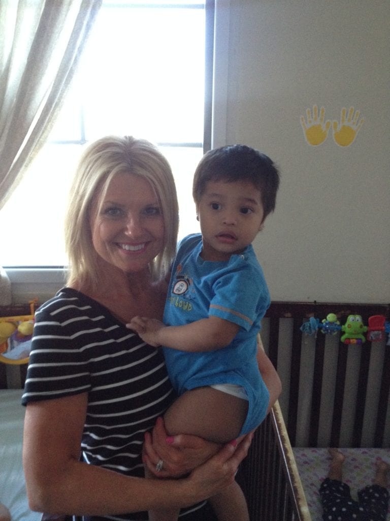Holly holding young child in Guatemala